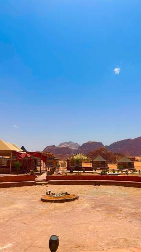 a view of a desert with mountains in the background at Wadi Rum Luxure desert Camp in Wadi Rum