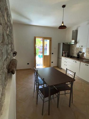 a kitchen and dining room with a table and chairs at Is Janas in Ulassai