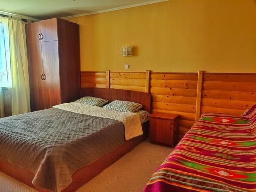 a bedroom with a bed and a cabinet and a bed sidx sidx sidx at Dream House in Yaremche