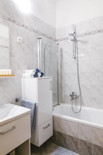 a bathroom with a shower and a tub and a sink at Villa Maria in Koper