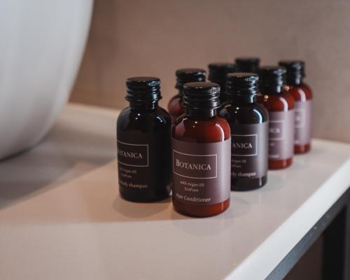 a row of bottles of sauce sitting on a counter at ELA FIVE RESIDENCES in Athens