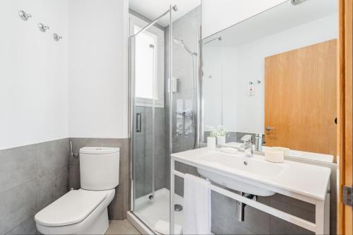 a bathroom with a toilet and a sink and a shower at The Corner Apartments by Aspasios in Barcelona