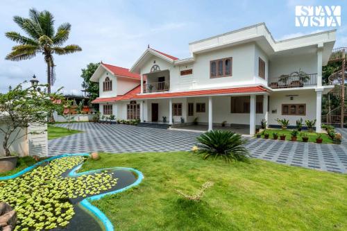 a house with a lawn in front of it at StayVista at Spice Notes - Breakfast Included in Munnar