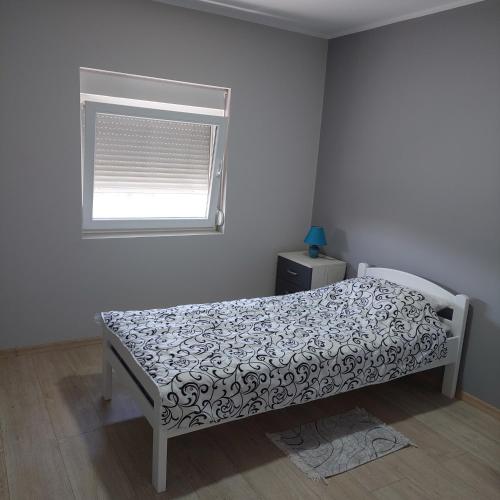 Кровать или кровати в номере Apartman BUONGIORNO