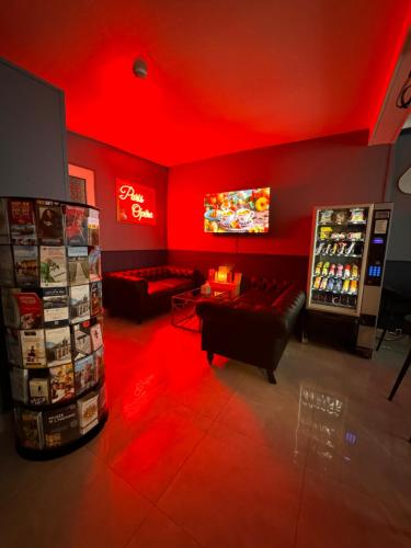 a living room with a red ceiling and a tv at HOTEL LOUVAIN in Paris