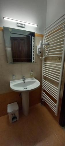 a bathroom with a sink and a mirror at Amaryllis House in Platamonas