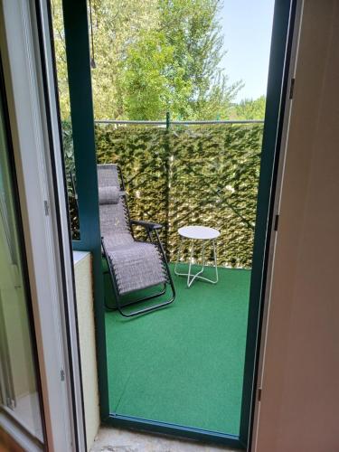 a balcony with a table and two chairs on a patio at Guest house Slatki Snovi in Knin