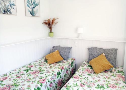 two beds sitting next to each other in a room at AGAMARI La Mata Torrevieja sun apartment in Torrevieja