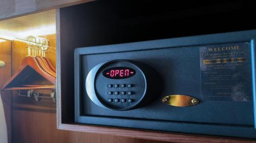 a microwave oven with a clock on top of it at Swiss-Belhotel Bogor in Bogor