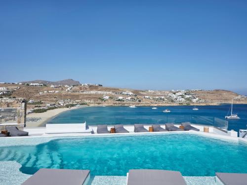 a swimming pool with a view of the ocean at Pietra e Mare - Mykonos Moments in Kalo Livadi