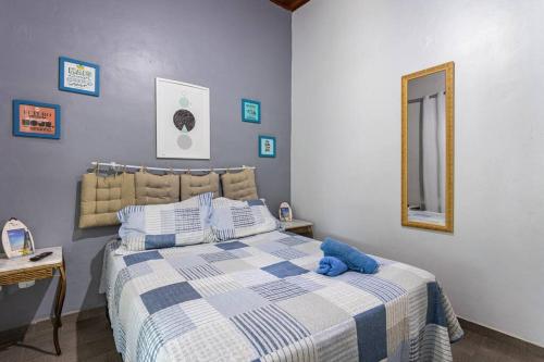 a bedroom with a bed with a blue stuffed animal on it at Casa Privativa com Piscina, Churrasqueira, Mesa de Sinuca in Iguaba Grande