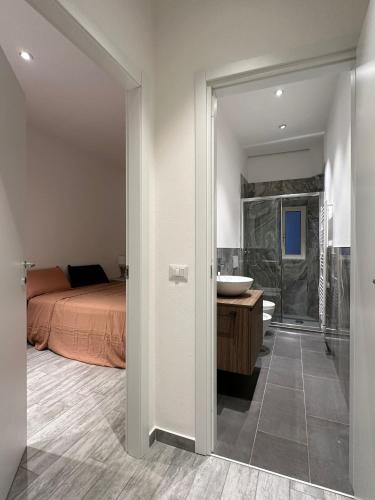 a bedroom with a bed and a bathroom with a sink at appartamento Pekoe in Modena