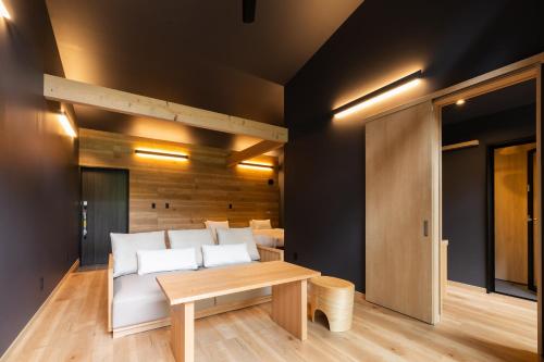 a living room with a couch and a table at 7c villa and winery in Fujikawaguchiko