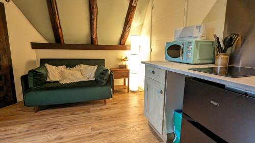 a living room with a couch and a microwave at Bonfarto Locations in Urval