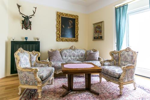 uma sala de estar com duas cadeiras e uma mesa em Villa Thalhof em Bad Gleichenberg