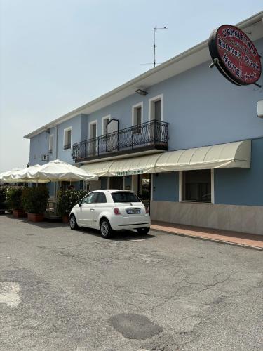 a white car parked in front of a building at Hotel Ristorante Amalfitana in Dello