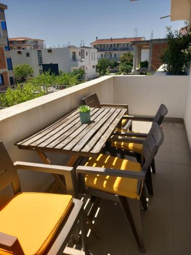 a wooden table and chairs on a balcony at Vila Nina Donji Štoj in Ulcinj