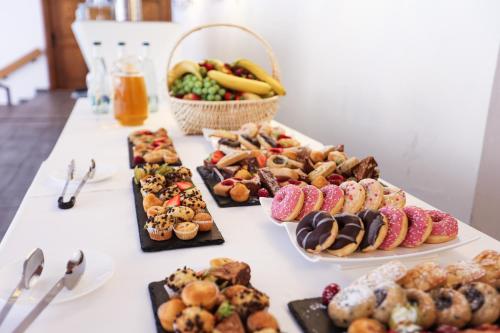 a table topped with different types of pastries and desserts at Le Saint Georges in Gruyères