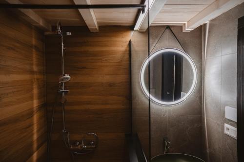 a bathroom with a mirror and a sink at Horská Chata pod Soliskom in Vysoké Tatry