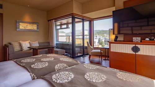 a bedroom with a bed and a living room at Sora Niwa Terrace Kyoto Bettei in Kyoto