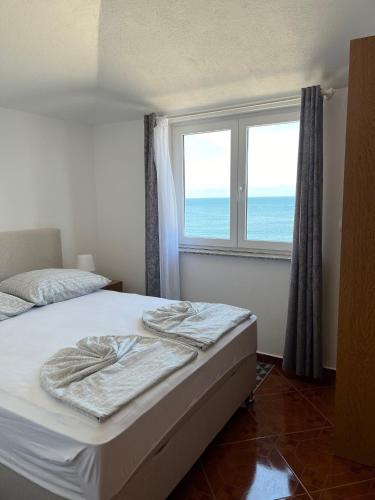 a bedroom with a bed and a window at Guest House Laura in Crveni Vrh
