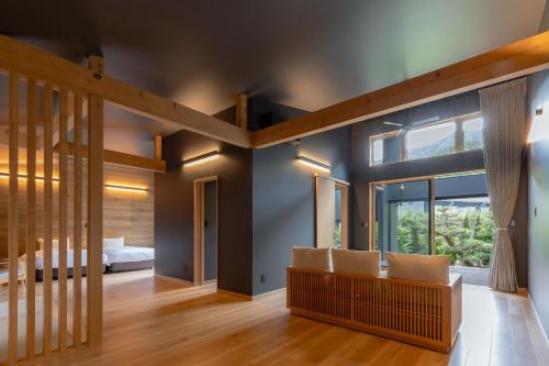 a bedroom with a bed and a large window at 7c villa and winery in Fujikawaguchiko