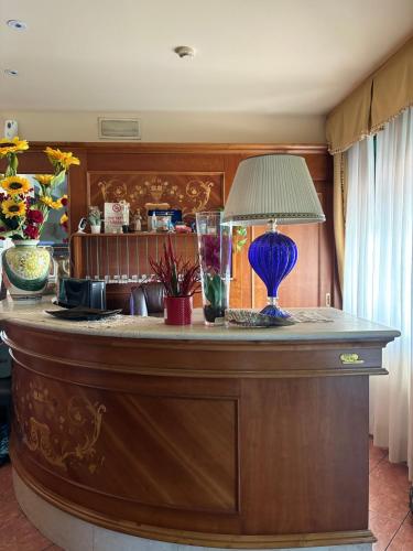 a table with a lamp on top of it at Hotel Ristorante Amalfitana in Dello