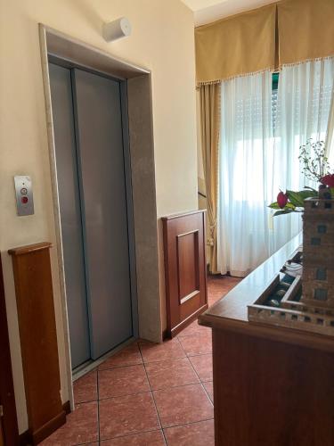 a room with a large glass door with a window at Hotel Ristorante Amalfitana in Dello