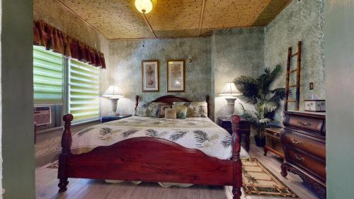 a bedroom with a wooden bed in a room at Casa Coquina del mar Bed and Breakfast in Titusville