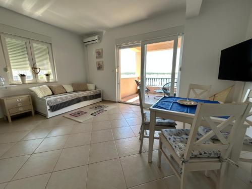 a living room with a couch and a table at Villa MILICA in Barbat na Rabu