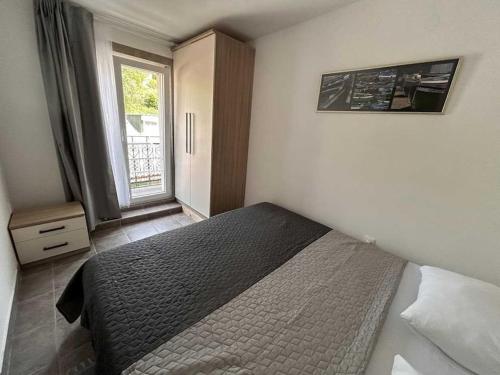 a bedroom with a bed and a window in it at Tip- top in Karlobag