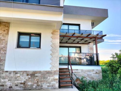 a house with a staircase in front of it at Liz Villa in Ortaca