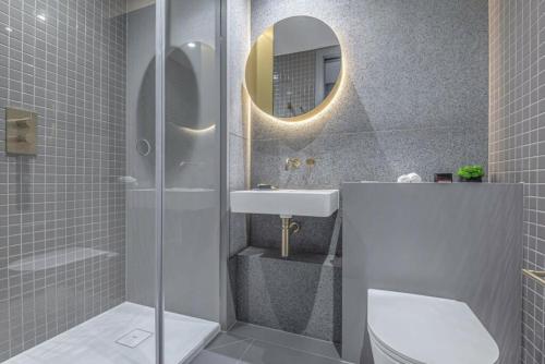 a bathroom with a sink and a toilet and a mirror at Greenwich-the 02 two in London