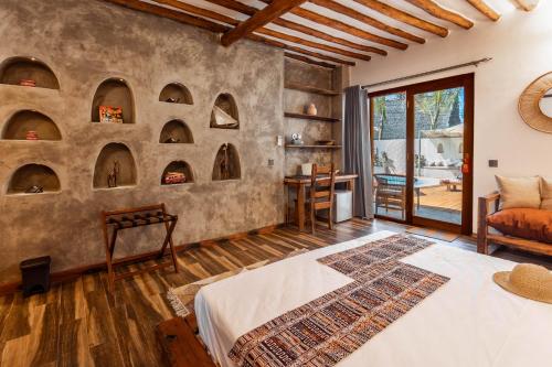 a bedroom with arches on the wall at Casa Ananda Boutique Hotel in Paje