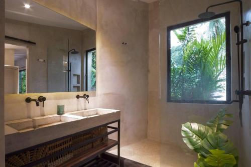 a bathroom with a sink and a large mirror at VILLA MARTINA with private swimming pool in El Nido