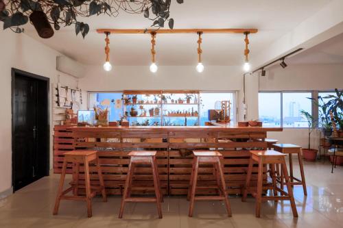 a bar in a restaurant with wooden stools at Sixteen By Sixteen in Lagos