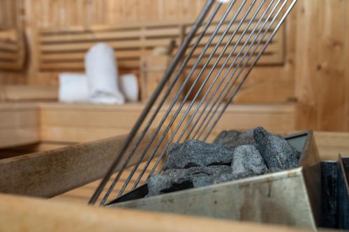 a pile of coal on a grill in a kitchen at AvenidA Panorama Suites in Kaprun