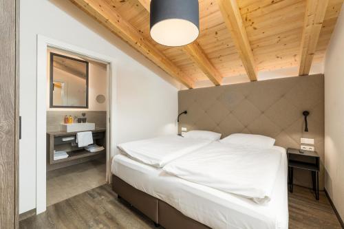 a bedroom with a large white bed in a room at AvenidA Panorama Suites in Kaprun