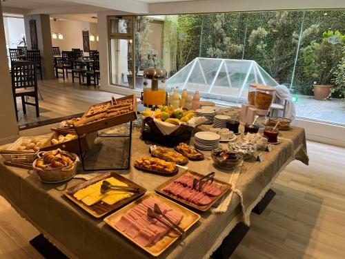 a table with a buffet of food on it at Kenton Palace Bariloche in San Carlos de Bariloche