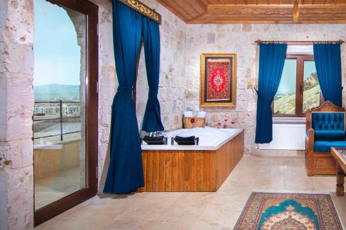 a room with a bath tub and a window at Black Stove Cappadocia in Ortahisar