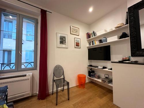 un salon avec une chaise et une télévision dans l'établissement Collioure Duplex, à Collioure