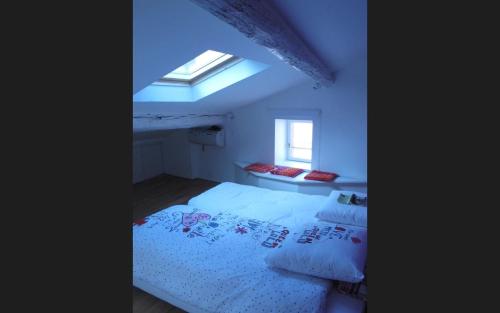 une chambre avec un lit et une lucarne dans l'établissement Collioure Duplex, à Collioure