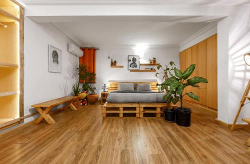 a bedroom with a bed and a wooden floor at Sixteen By Sixteen in Lagos