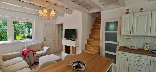 a kitchen and living room with a table and chairs at Funny Füred in Balatonfüred