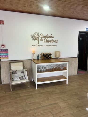 a white wall with a sign that reads centric the oliviers at Cantinho das Oliveiras in Geres