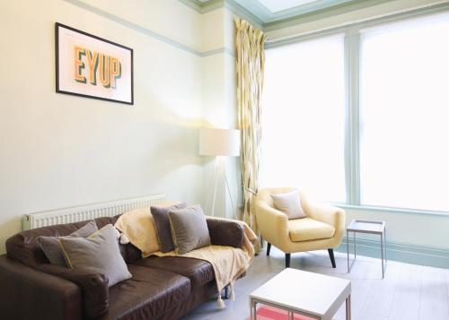 a living room with a couch and a chair at Glebe Apartment 1 in Harrogate