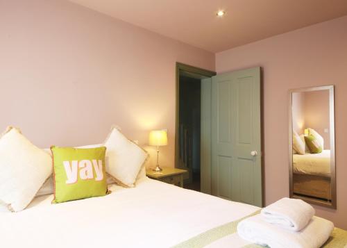 a bedroom with a bed with a yay pillow on it at Glebe Apartment 1 in Harrogate