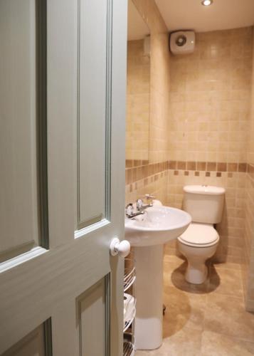 a bathroom with a sink and a toilet at Glebe Apartment 1 in Harrogate