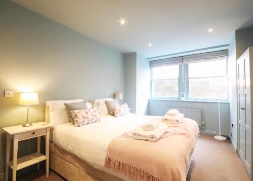a bedroom with two beds and a window at Glebe Apartment 1 in Harrogate