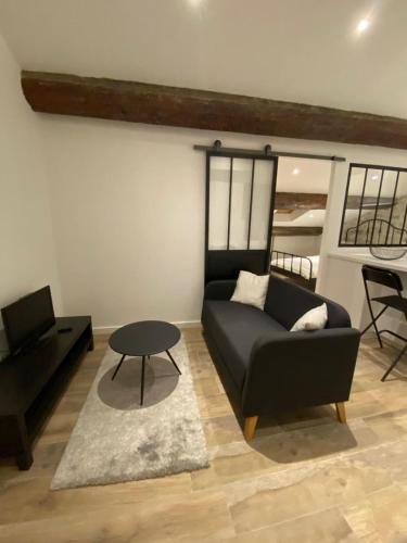 un salon avec un canapé et une table dans l'établissement Cozy apartment close to the sea, à Toulon